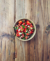 Spicy Tomato and Pepper salsa. Rustic wooden background. Top view. Copy space. 
