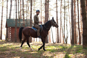 Man With Helmet Riding a Horse in Forest