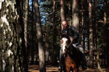 Fototapeta premium Young Man Riding a Horse