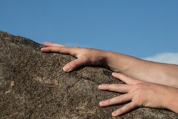 Giving a helping hand up a mountain. Helping someone in need concept.
