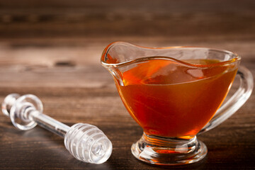 Honey in glass bowl on the table.