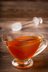 Honey in glass bowl on the table.