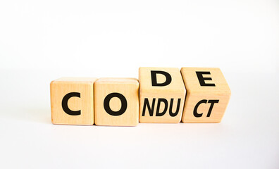 Code of conduct symbol. Turned the wooden cube and changed the word code to conduct. Beautiful white background. Business and code of conduct concept. Copy space.