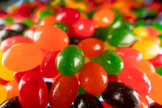 Close up high resolution macro photograph of multiple colors and flavors of jellybeans