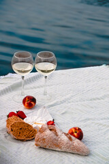 romantic dinner on the beach with wine and cheese