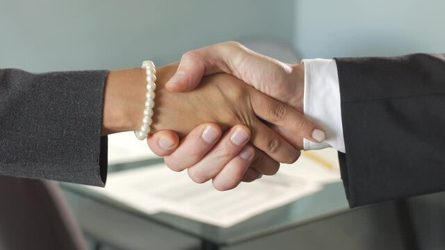 Close-up Of A Corporate Handshake Between A Man And A Woman