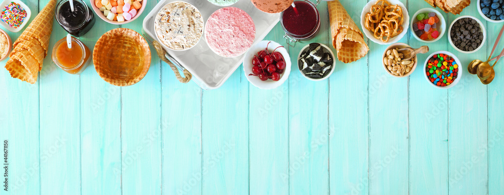 Poster summer ice cream buffet with assorted of flavors and sweet toppings. above view table scene on a blu