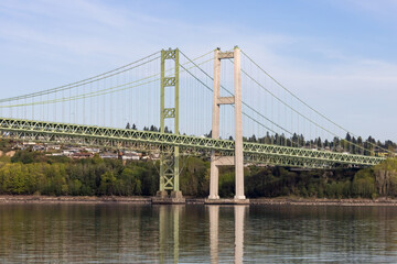 Fototapeta na wymiar Tacoma Narrrows Bridge reflected in the sound