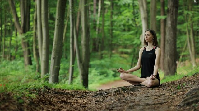 Woman meditating at forest