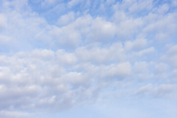 light fluffy white clouds floating in early spring morning