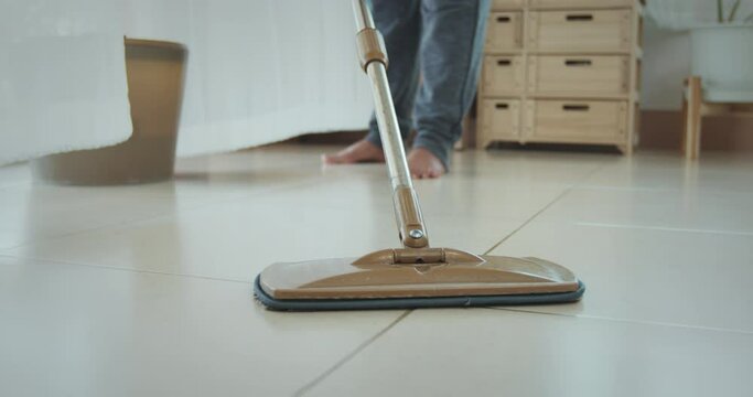 Woman cleaning the floor with a microfiber wet mop pad