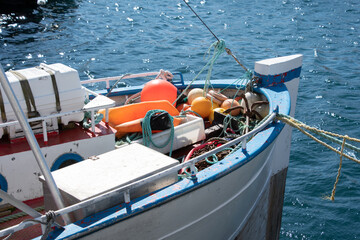The bow of a white fishing boat in Honningsv&aring;g, Norway.