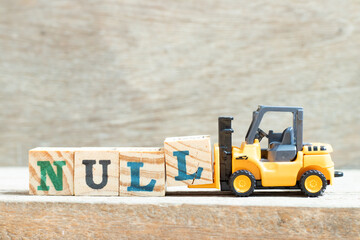 Toy forklift hold letter block l to complete word null on wood background