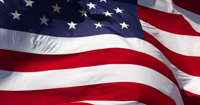 4k Slow Motion Real American Flag Waving In Wind Against a Deep Blue Sky
