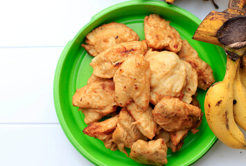 Top View Homemade Banana Fritter or  Pisang Goreng or Fried Banana, Traditional Indonesian Dish Made from Banana with Flour Batter Coating and Deep Fried, Copy Space for Text