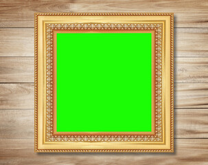 The antique gold frame on wooden wall background , for Graphics design.