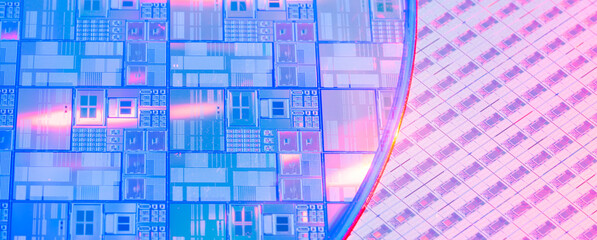 silicon wafer with microchips reflecting different colors.