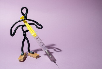 Figurine of man with syringe,  concept of vaccinations and medicine.