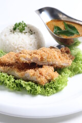 crispy deep fried chicken chop fish cutlet serve with nyonya spicy curry sauce and steam fragrant white jasmine rice and lettuce