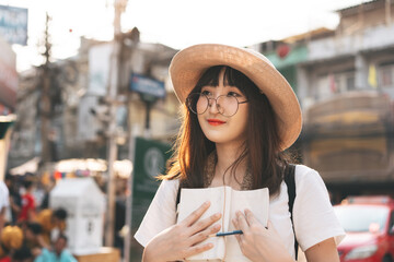 Happy smile young adult asian woman traveller wear eyeglasses travel on day.