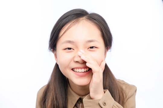 A Little Asian Girl Whispering In A White Background