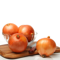 Gold onion on cutting board on white background 