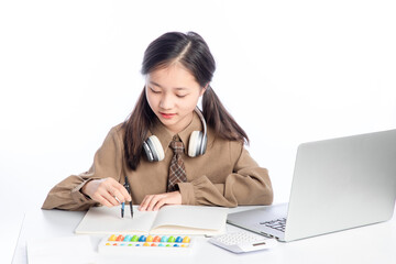 Little Asian girl receiving online education on white background