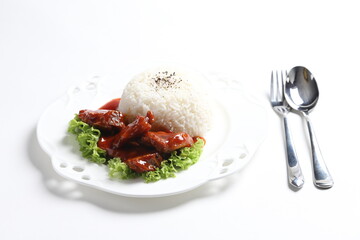 stir fried fresh pork, fish, chicken meat in sweet and sour ketchup tomato sauce serve with steam fragrant white jasmine rice and lettuce