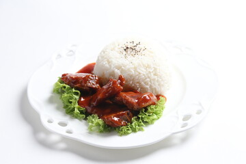 stir fried fresh pork, fish, chicken meat in sweet and sour ketchup tomato sauce serve with steam fragrant white jasmine rice and lettuce