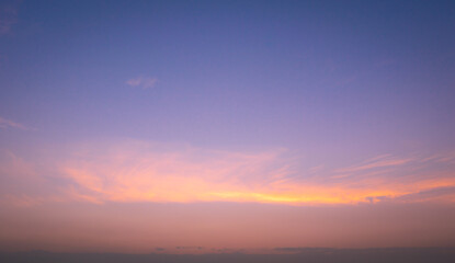 Fototapeta premium Beautiful Vivid sky painted by the sun leaving bright golden shades.Dense clouds in twilight sky in winter evening.Image of cloud sky on evening time.Evening Vivid sky with clouds.