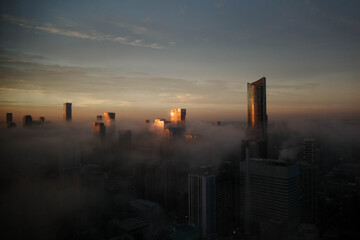 sunrise over the foggy city
