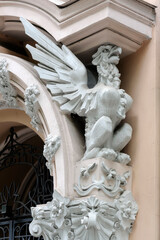 White plaster griffin on the old building facade in Kyiv Ukraine