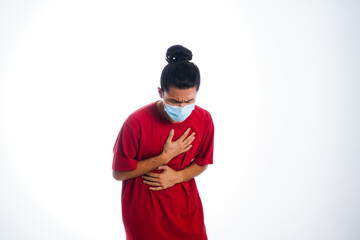 Covid19, the concept of health care and medicine. A young man standing in a face mask with hand gesture "i'm sick", supporting social distance