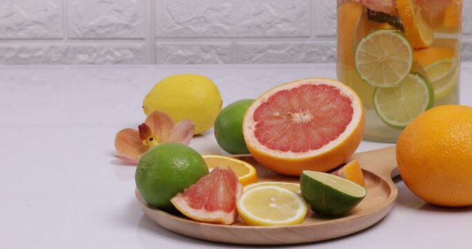 Making citrous fruits infusion water with lime, lemon, orange and grapefruit.