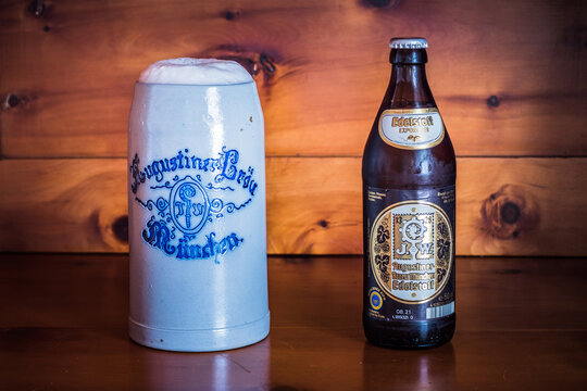 Munich, Germany - May 24 2021: Augustiner Edelstoff Bavarian Beer Bottle and Liter Stein or Mug.