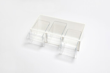 Plastic drawer with pull-out containers isolated on white background. High-resolution photo.