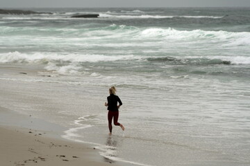 Female runner in shallow water  near Big ROck Reef, La jolla