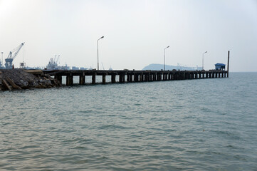 The jetty for loading in the sea on blue sky background with copy space.      