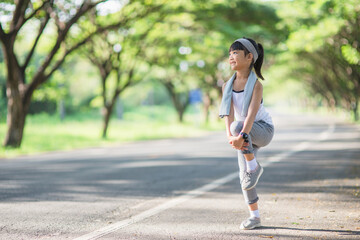 Cute asian girl exercise in gardent background