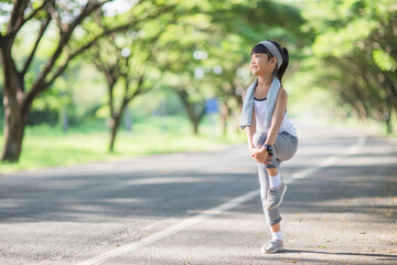 Cute asian girl exercise in gardent background