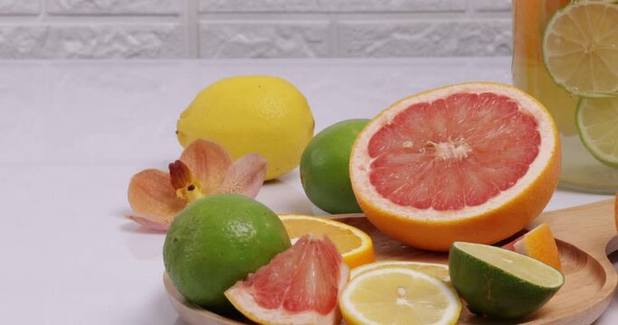 Making citrous fruits infusion water with lime, lemon, orange and grapefruit.