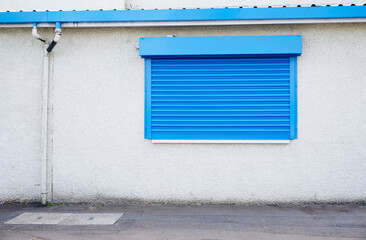 Shop front with blank sign and closed shutter door
