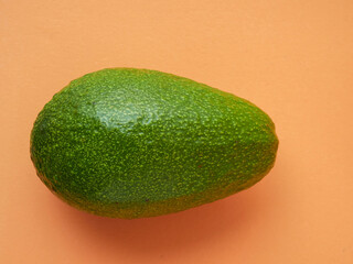 Organic avocado with seeds, avocado halves and whole fruit on a yellow background. Top view. Pop art design, creative concept of summer food.