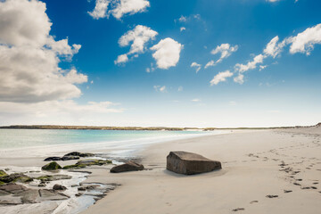 Gurteen bay and beach, near Roundstone town, county Galway, Ireland, warm sunny day, cloudy sky. Beautiful Irish landscape, with clear water and light color sand