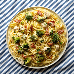 Homemade Chicken Bacon Broccoli Alfredo on a plate, top view. Flat lay, overhead, from above.