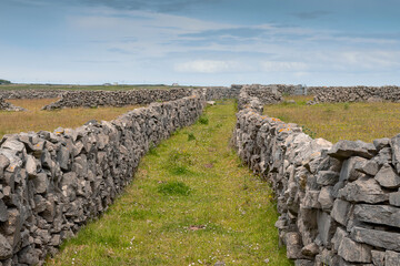Small walkway between stone fences of Inishmore, Aran Islands, County Galway, Ireland. Irish landscape