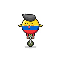 The cute colombia flag badge character is riding a circus bike