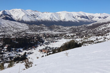 Snowy village with hotel and sky lifts on the top of the mountains in bariloche patagonia, la cathedral is the best skiing spot in south america