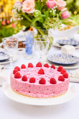 Selective focus photo. Celebration. Berry cake and decorated dinner table in garden.