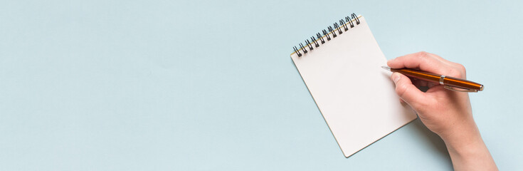 Wide banner with copy blank space and hand writting on spiral notebook.